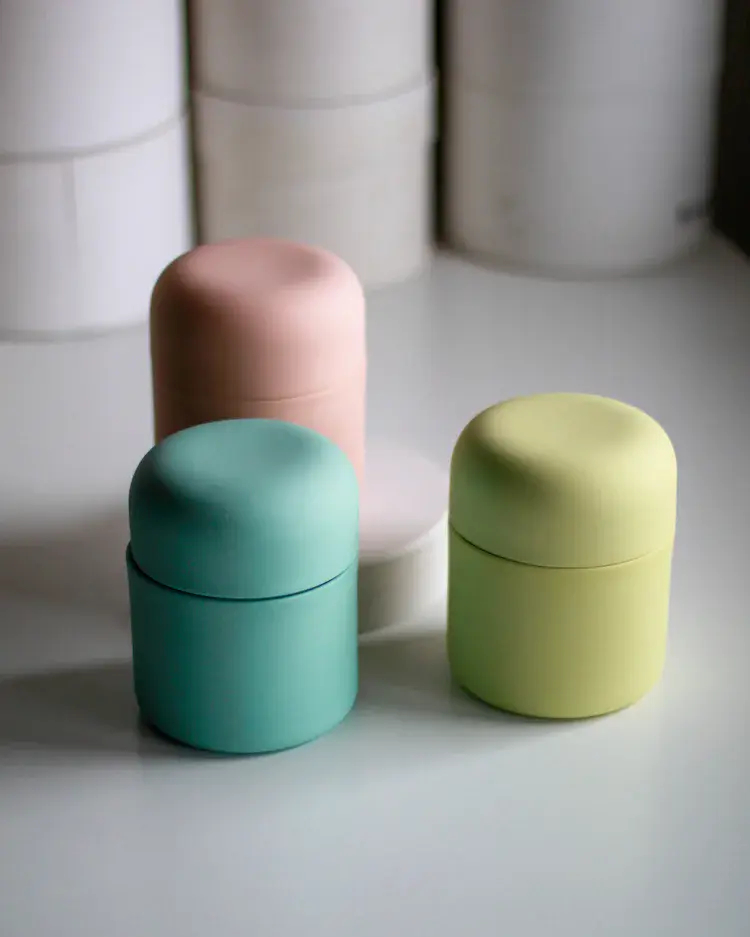 Unfired slip-cast porcelain vessels on work table