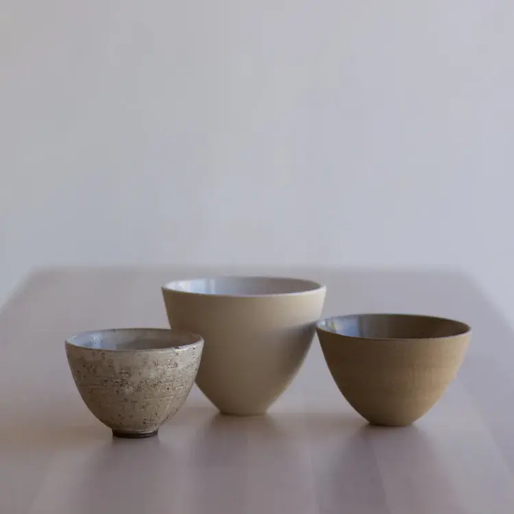 Collection of stoneware homeware pieces on wooden surface