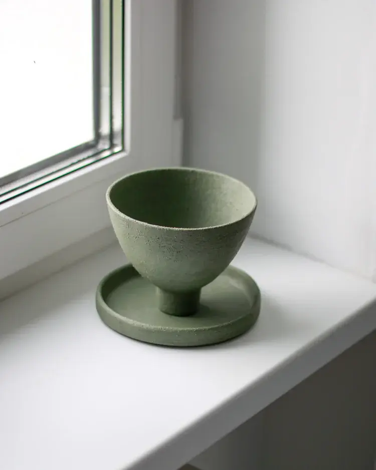 Stoneware teacup and saucer with hand-built imperfections