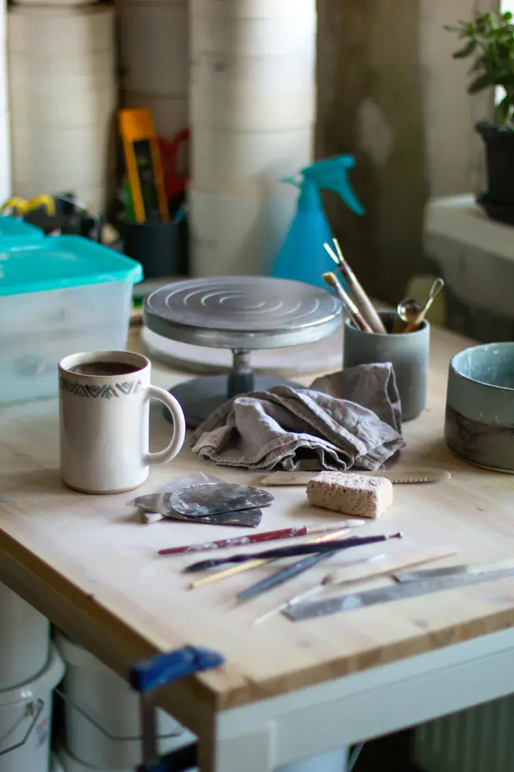Kiln shelves stacked with ceramic pieces before firing