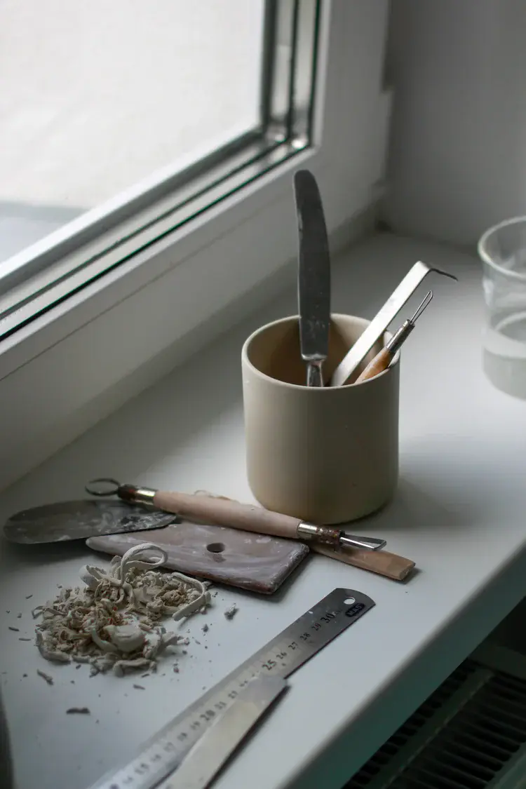 Freshly thrown pots resting on wooden bat